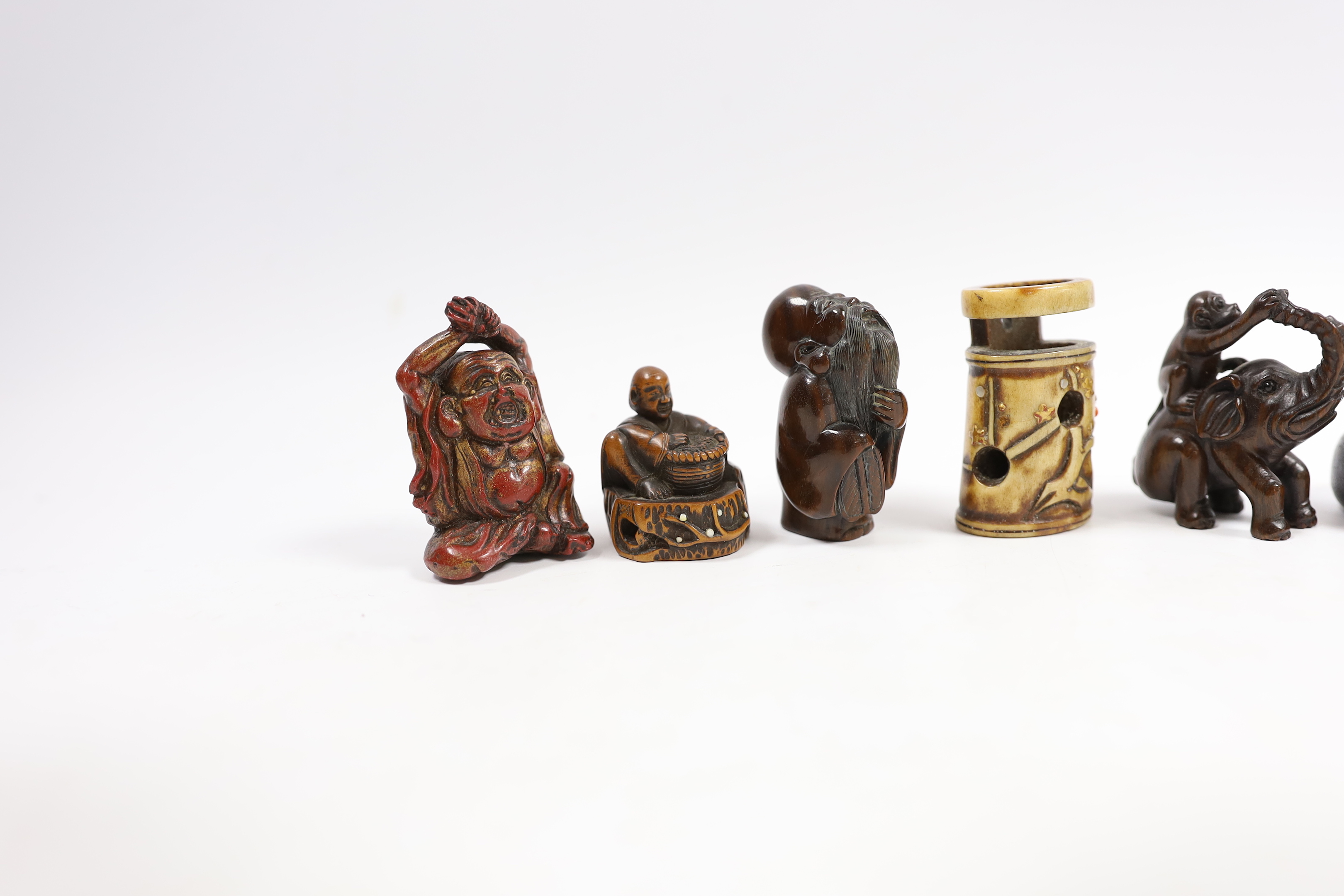 A group of six Japanese netsuke in wood, staghorn and lacquer, 19th century and later